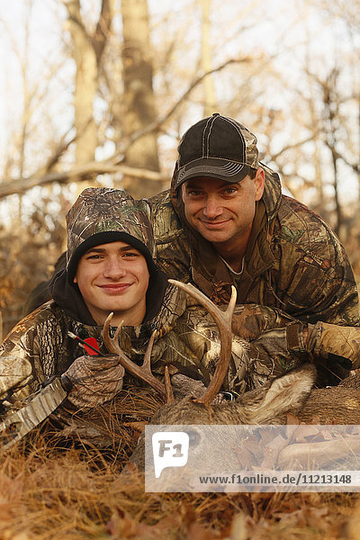 Portrait of Father And Son Hunters With A Dead Deer