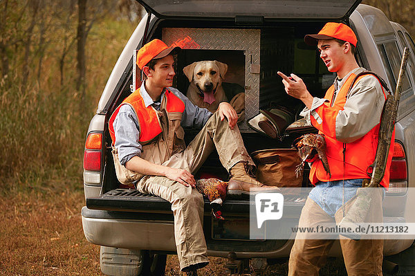 Young Hunters With Dog On Tailgate