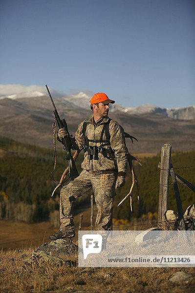 Big Game Hunter With Western Elk Rack On Back