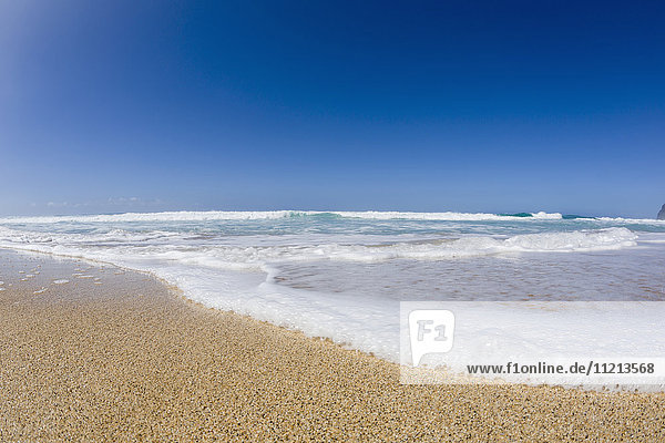 Wasser  das an den Strand gespült wird  Barking Sands (Polihale Beach) auf West Kauai  Ansicht mit Fischaugenobjektiv; Kauai  Hawaii  Vereinigte Staaten von Amerika'.