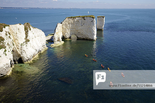 Lime stone sea stacks with canoeists  Dorset