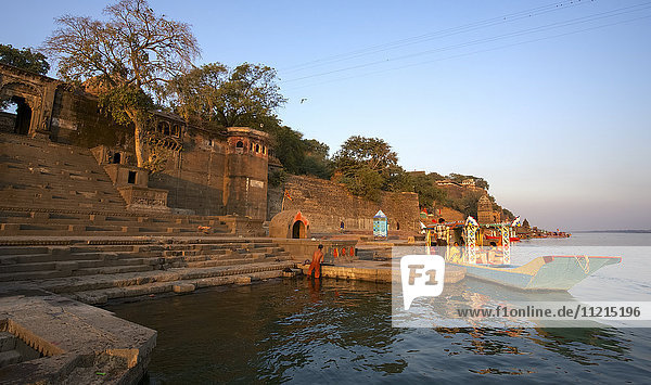 Hindu temple and pilgrims on the bathing ghats of the Namada River  India