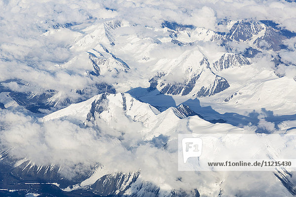 'Aerial view of clouds twisting among the snowy peaks of the Alaska Range  interior Alaska; Alaska  United States of America'