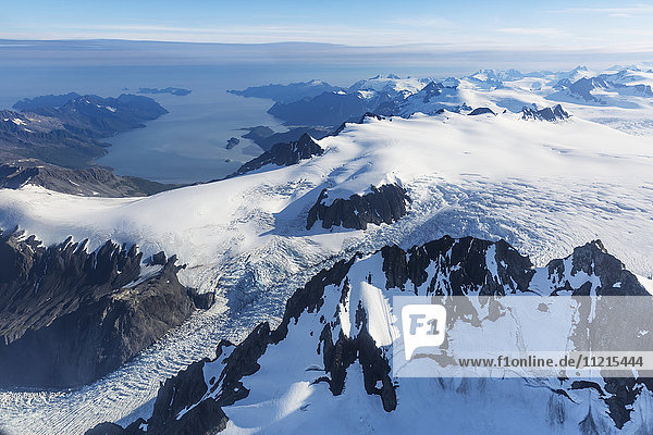 'Aerial view of the Harding ice field and glaciers decending from its snowy peaks  Prince William Sound in the background  Kenai Peninsula  Southcentral Alaska; Seward  Alaska  United States of America'