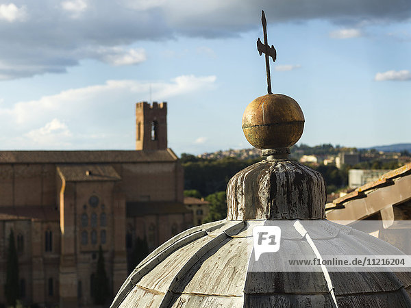 'Cross on top of a dome roof of Siena Cathedral; Siena  Italy'