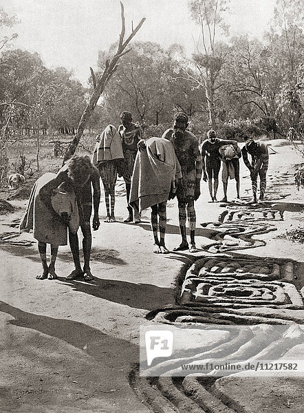 The Bora Ceremony of eastern Australia. Boys were initiated into the sacred mysteries of the tribe  seen here being led blindfolded along the path from one part of the Bora ground to another. On each side of the path are sacred drawings which they may not see till a later stage of the ceremony. After a 19th century photograph. From Customs of The World  published c.1913.