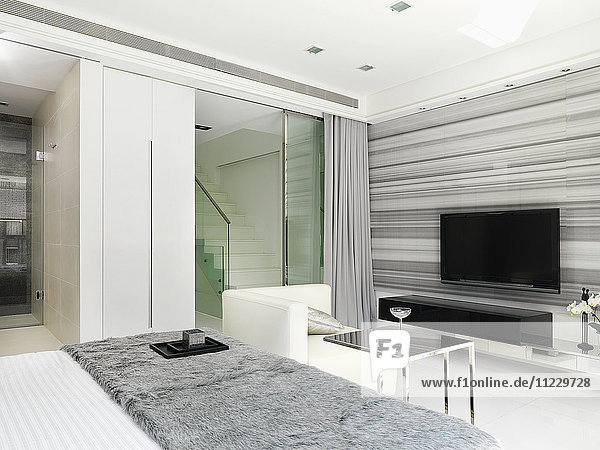 Sitting area and television in modern bedroom
