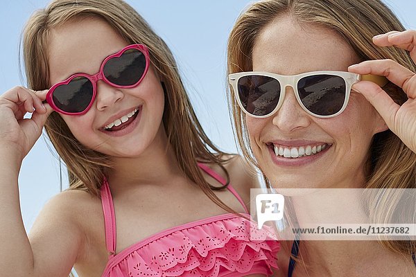 Mother and daughter wearing sunglasses