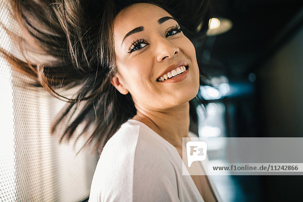 Young woman swinging hair  smiling