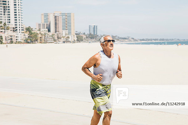 Senior man  running on beach  Long Beach  California  USA
