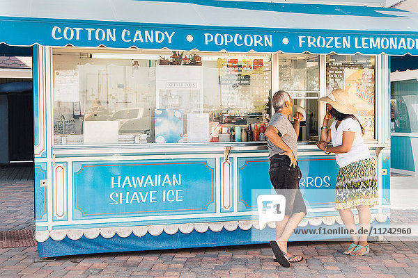 Senior couple standing beside refreshment stand  Long Beach  California  USA