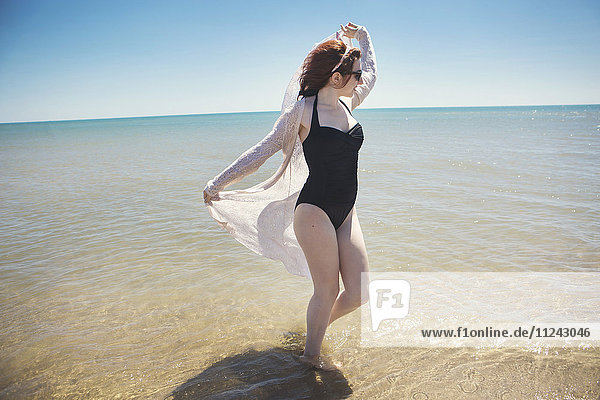 Young woman dancing in sea Narbonne France