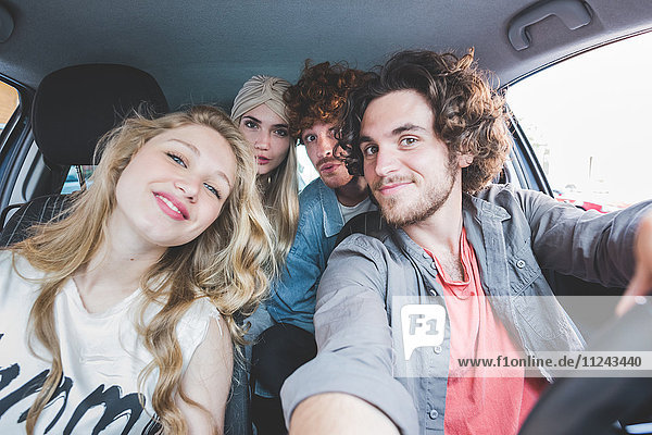 Friends taking selfie in car