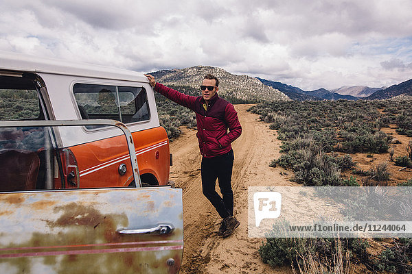 Man with vehicle on scrubland by mountains  Kennedy Meadows  California  USA
