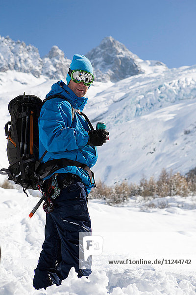 Portrait of male snowboarder wearing ski goggles in deep snow  Trient  Swiss Alps  Switzerland