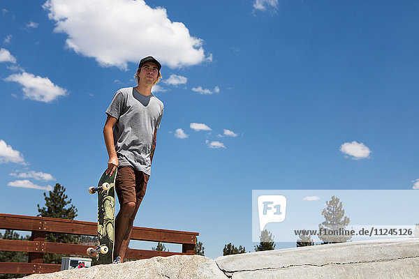 Young male skateboarder in skate park  Mammoth Lakes  California  USA