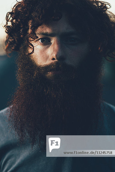 Portrait of staring  bearded young male hipster