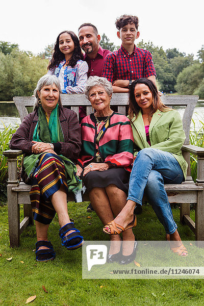 Portrait of four generation family  beside lake  smiling