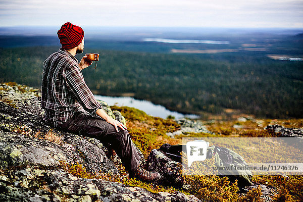 Hiker enjoying view on cliff top  Keimiotunturi  Lapland  Finland