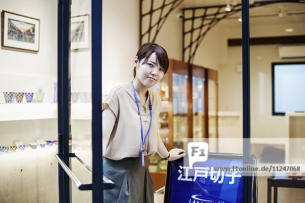 Saleswoman in a shop selling Edo Kiriko cut glass in Tokyo  Japan.