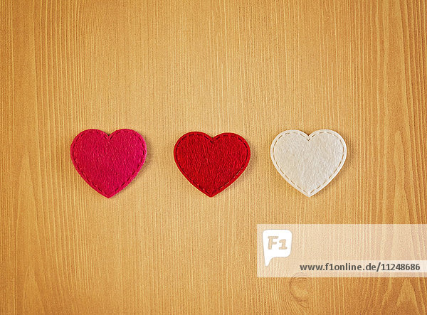 Three hearts cut out from fabric