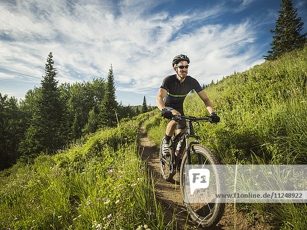 Mature man cycling outdoors