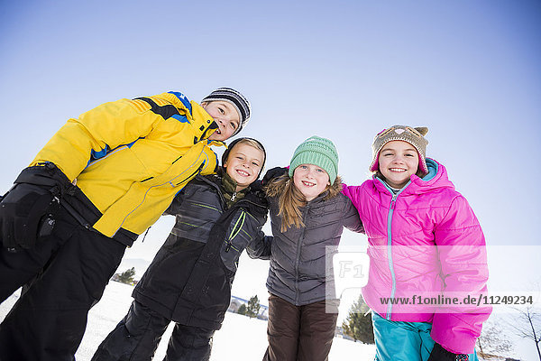 Children (8-9 10-11 ) standing in snow