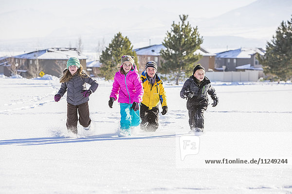 Children (8-9  10-11) running in snow