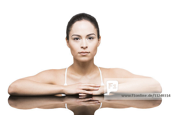 Portrait of woman leaning on mirror