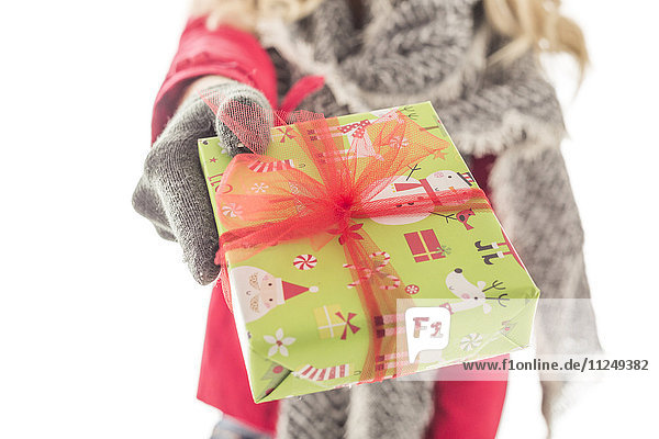 Young woman holding Christmas present