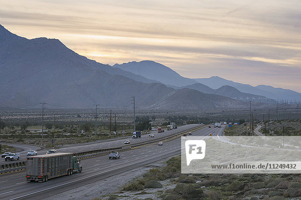 I-10 highway along mountains at sunset
