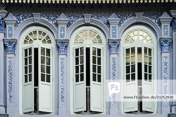 Traditional shophouse windows open out onto a street in the Orchard Road neighborhood in Singapore  Southeast Asia  Asia