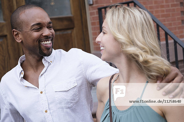 Smiling couple walking in residential district