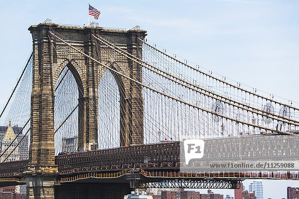 USA  New York State  New York City  Brooklyn Bridge with American flag on top