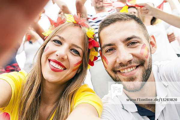Portrait of Spanish soccer fans with face paint