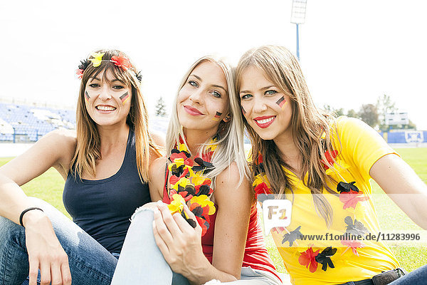 Portrait of three female soccer fans