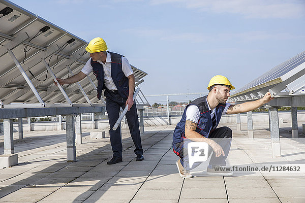 Construction workers checking solar panel structures