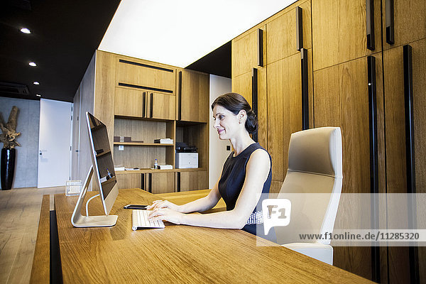 Businesswoman in lobby working on computer