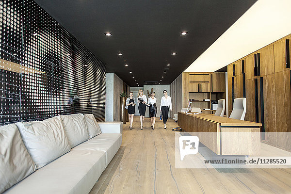 Group of businesswomen walking in lobby