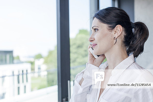 Businesswoman in office using phone