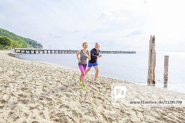 Couple jogging along the beach
