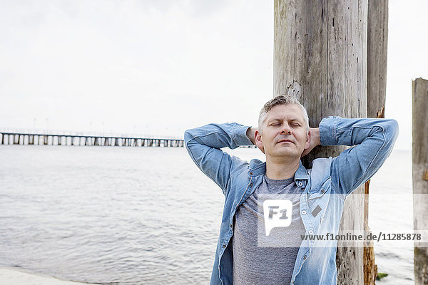 Portrait of man with gray hair on beach relaxing