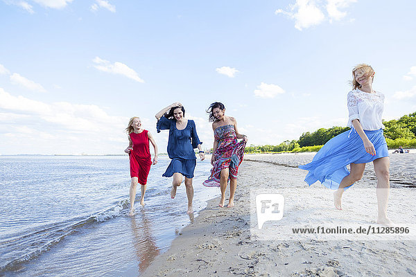 Group of women take a walk along the beach