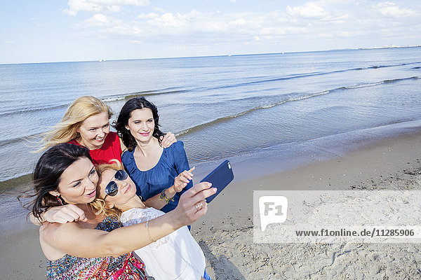 Women on beach taking a selfie
