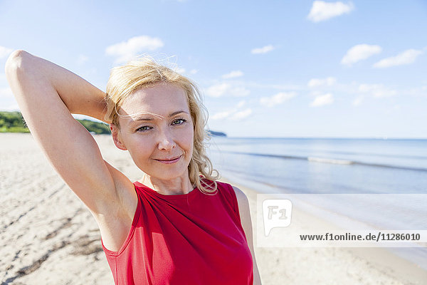 Portrait of woman with blond hair on beach