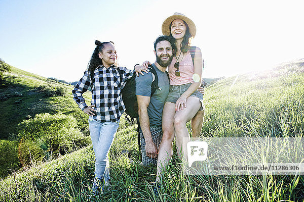 Portrait of smiling family posing on hill