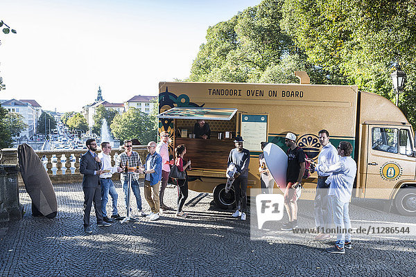 Group of customers waiting at food truck