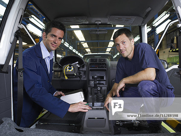 Two Men Inspecting Car