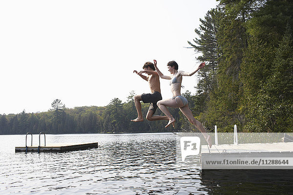 Couple Jumping from Dock