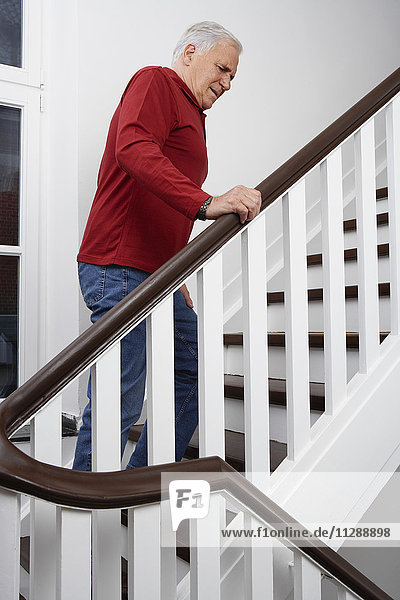 Man in Pain Climbing Stairs